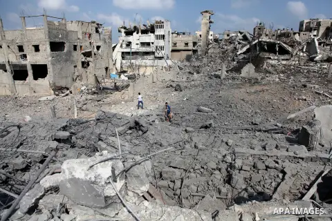 Palestinians inspect destroyed houses and the area where the Al-Wafaa hospital stood in the Al-Shejaea neighbourhood of Gaza City on August 5, 2014, after a 72-hour truce agreed by Israel and Hamas went into effect follo...