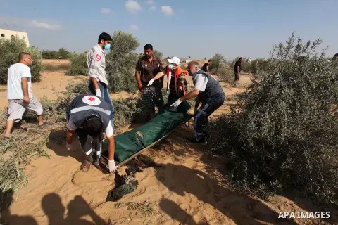 Medics carry the dead body of a Palestinian man after removing it from under the rubble of a house which witnesses said was destroyed during the Israeli offensive, in the east of Rafah in the southern Gaza Strip August 5...