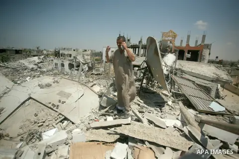 Palestinians search through rubble of their destroyed houses hit by Israeli strikes in Khuzaa, east of Khan Younis, in the northern Gaza Strip, Tuesday, Aug. 5, 2014. Israel and Hamas began observing a temporary cease-fi...