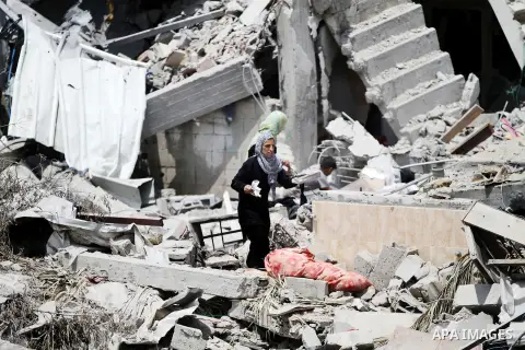 Palestinians search through rubble of their destroyed houses hit by Israeli strikes in Khuzaa, east of Khan Younis, in the northern Gaza Strip, Tuesday, Aug. 5, 2014. Israel and Hamas began observing a temporary cease-fi...