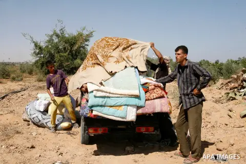 Palestinians carry their belongings on a tricycle, evacuated from their house, which witnesses said was badly damaged during the Israeli offensive, in the east of Rafah in the southern Gaza Strip August 6, 2014. Israel p...