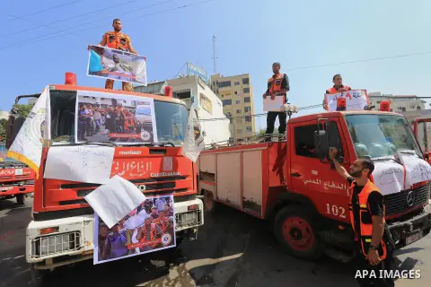 Palestinian members of civil defense take part a protest against the Israeli aggression on them during the war on Gaza Strip, in Gaza city on August 7, 2014. The ceasefire, which came into effect on August 5, has brought...