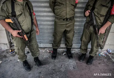 Palestinian security forces stand guard as demonstrators attend a rally in support of the Hamas movement in downtown Gaza City on August 7, 2014 while diplomatic efforts entered a final countdown in Cairo as Egyptian med...