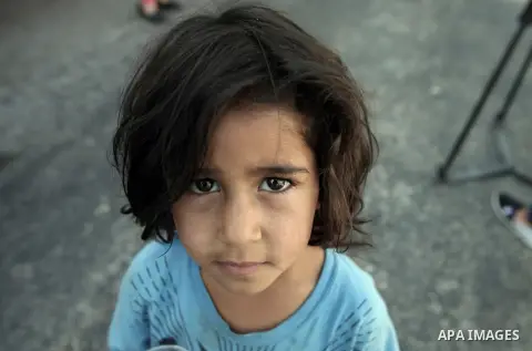 A Palestinian girl poses for a picture during a protest against the Israeli offensive on Gaza Strip, outside the Red Cross headquarter in east Jerusalem's Sheikh Jarrah neighborhood on August 07, 2014, while diplomatic e...