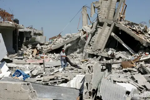 A Palestinian man searches in his destroyed house which was hit in an Israeli air strike on Abasan, east of the southern Gaza Strip town of Khan Yunis and close to the border with Israel on August 7, 2014. Several people...