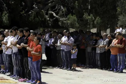 Palestinian muslim worshipers take part in Friday prayers at the Al-Aqsa mosque compound, Islam's third holiest site, in the Old City of Jerusalem on August 08, 2014. Photo by Saeed Qaq