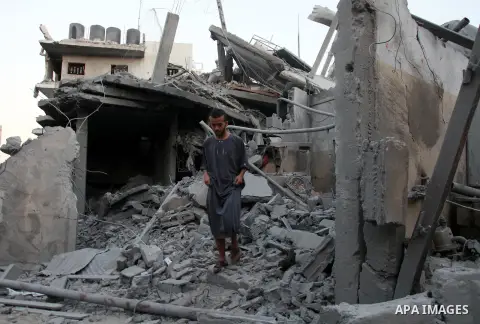 A Palestinian man inspects a destroyed buildings in the Jabalia refugee camp in the northern Gaza Strip on August 8, 2014. Israel launched air strikes across the Gaza Strip on Friday in response to Palestinian rockets fi...