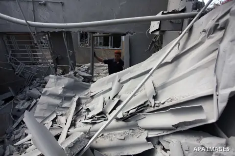 Palestinians inspect the remains of their houses, which witnesses said was hit by an Israeli air strike in Jabalia refugee camp in the northern Gaza Strip on August 9, 2014. Israel launched more than 20 aerial attacks in...