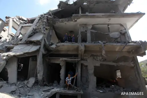 Palestinians inspect the remains of their houses, which witnesses said was hit by an Israeli air strike in Jabalia refugee camp in the northern Gaza Strip on August 9, 2014. Israel launched more than 20 aerial attacks in...