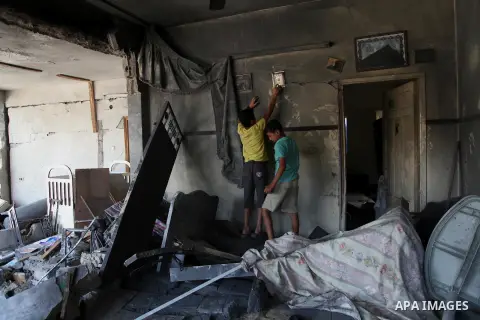 Palestinian children inspect a damaged house was hit by an Israeli military strike in Gaza City on August 10, 2014. A senior Hamas official said there was a "weak" possibility that Gaza truce talks would succeed and that...