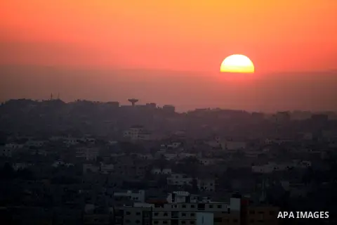 A picture shows the sun rising over Gaza city on August 11, 2014. Palestinian and Israeli negotiators on Sunday said they had accepted an Egyptian proposal for a new 72-hour truce with Israel, clearing the way for a poss...