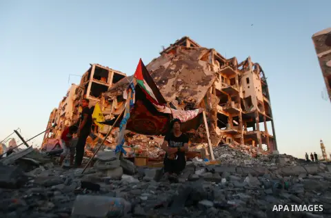 A Palestinian sits in front of a tent outside houses, which witnesses said were destroyed in an Israeli offensive, during a 72-hour truce in Beit Lahiya town in the northern Gaza Strip August 12, 2014. Talks to end a mon...