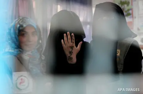 A displaced Palestinian bride celebrates her marriage at a UN school that has been turned into a temporary shelter, in Jabalia in the northern Gaza Strip on August 12, 2014. Thousands of Palestinians people live in the U...