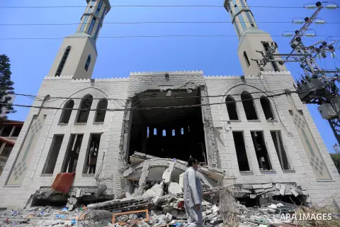 Palestinian worshipers perform Friday prayers next to the remains of a mosque which witnesses said was destroyed by an Israel air strike during the offensive, on the second day of a five-day ceasefire in Gaza City August...