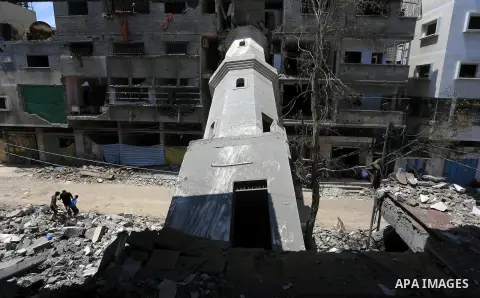Palestinian worshipers perform Friday prayers next to the remains of a mosque which witnesses said was destroyed by an Israel air strike during the offensive, on the second day of a five-day ceasefire in Gaza City August...