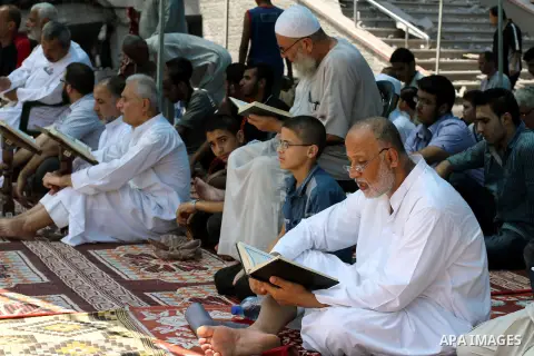 Palestinian worshipers perform Friday prayers next to the remains of a mosque which witnesses said was destroyed by an Israel air strike during the offensive, on the second day of a five-day ceasefire in Gaza City August...