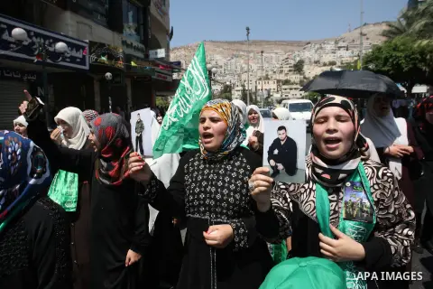 Palestinian women wave Islamist flags as they take part in a demonstration is support of Gaza after Friday prayers in the West Bank city of Nablus August 15, 2014. Two successive truces since Monday, expected to last thr...