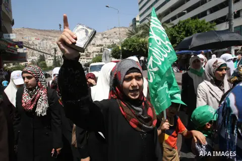 Palestinian women wave Islamist flags as they take part in a demonstration is support of Gaza after Friday prayers in the West Bank city of Nablus August 15, 2014. Two successive truces since Monday, expected to last thr...