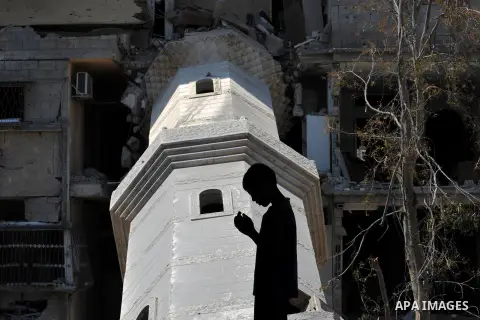 A Palestinian boy prays at a mosque which witnesses said was destroyed by an Israel air strike during the offensive, on the second day of a five-day ceasefire, in Gaza city on August 15, 2014. Israel and Palestinians are...