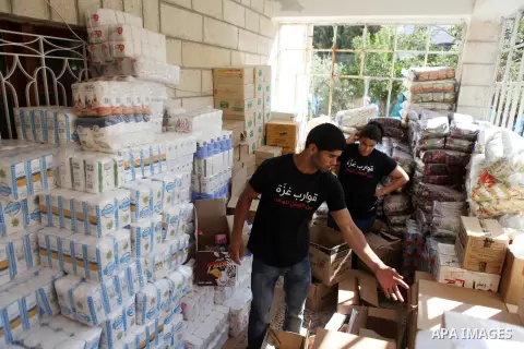 Palestinians carry aid supplies to be sent to the stricken in the Gaza Strip, in the West bank city of Ramallah on August 16, 2014. According to United Nations figures, around one quarter of a million people fled their h...