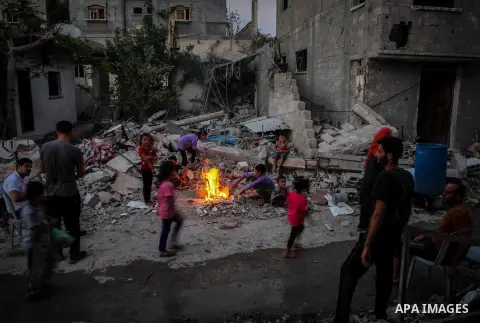 Palestinian children stand near the rubble of apartment buildings destroyed during fighting between Hamas and Israel in the town of Beit Hanoun, in the northern Gaza Strip, on August 16, 2014. The United Nations estimate...