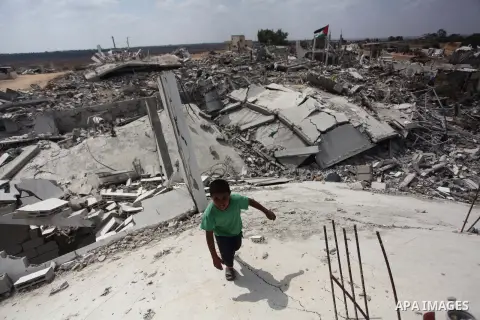 A Palestinian boy stands at the remains of his house which witnesses said was destroyed during the Israeli offensive in Johr El-Deek village near the central Gaza Strip August 17, 2014. Prime Minister Benjamin Netanyahu...