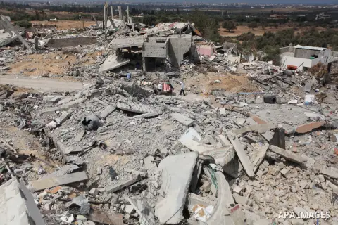 Palestinians inspect their destroyed house, which witnesses said was damaged during the Israeli offensive, on the fourth day of a five-day ceasefire in Johr El-Deek village near the central Gaza Strip August 17, 2014. Pr...