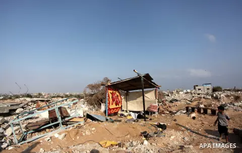 Palestinians inspect their destroyed houses, which witnesses said were damaged during the Israeli offensive, on the fourth day of a five-day ceasefire in Johr El-Deek village near the central Gaza Strip August 17, 2014....