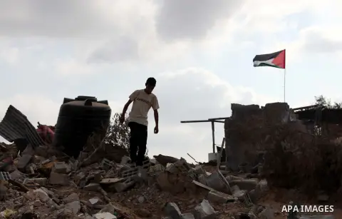 Palestinians inspect their destroyed houses, which witnesses said were damaged during the Israeli offensive, on the fourth day of a five-day ceasefire in Johr El-Deek village near the central Gaza Strip August 17, 2014....