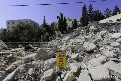 A Palestinian man inspects a building house demolished by israeli bulldozer, in the al-Tur neighborhood of Jerusalem on August 18, 2014 on the pretext that it was built without a permit. Israel rarely grants Palestinians...