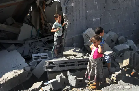 Palestinian children play on the rubble of their house, which witnesses said was destroyed during the Israeli offensive, in al-Shijaiya district in the east of Gaza city on August 18, 2014. Israeli and Palestinian negoti...