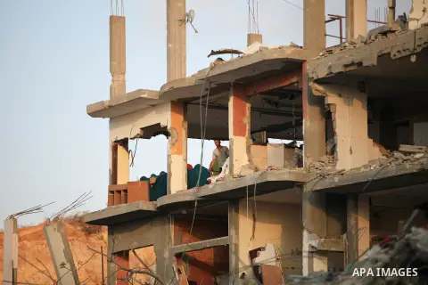 Palestinians walks past buildings destroyed during fighting between Hamas militants and Israel in the Al-Shaaf neighbourhood, in Gaza City, on August 18, 2014.Prime Minister Benjamin Netanyahu warned that Israel will hit...