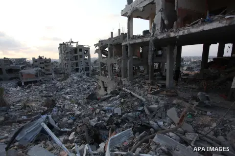 Palestinians walks past buildings destroyed during fighting between Hamas militants and Israel in the Al-Shaaf neighbourhood, in Gaza City, on August 18, 2014.Prime Minister Benjamin Netanyahu warned that Israel will hit...