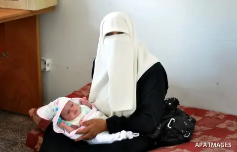 Displaced Palestinians attend a week ceremony for seven babies who had born in shelters, at a United Nations-run school sheltering displaced Palestinians from the Israeli offensive, in Gaza city August 19, 2014. The Unit...