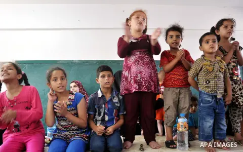 Displaced Palestinians attend a week ceremony for seven babies who had born in shelters, at a United Nations-run school sheltering displaced Palestinians from the Israeli offensive, in Gaza city August 19, 2014. The Unit...