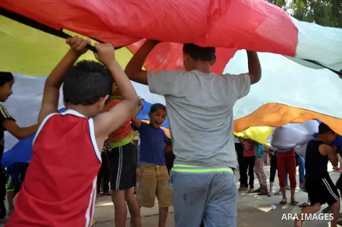 Displaced Palestinians play at a United Nations-run school sheltering displaced Palestinians from the Israeli offensive, in Gaza city August 19, 2014. The United Nations estimates about 10,000 Palestinian homes were dest...