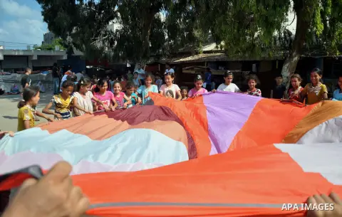Displaced Palestinians play at a United Nations-run school sheltering displaced Palestinians from the Israeli offensive, in Gaza city August 19, 2014. The United Nations estimates about 10,000 Palestinian homes were dest...