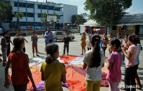 Displaced Palestinians play at a United Nations-run school sheltering displaced Palestinians from the Israeli offensive, in Gaza city August 19, 2014. The United Nations estimates about 10,000 Palestinian homes were dest...