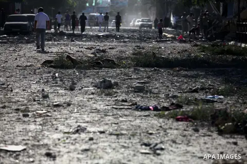 Palestinians walk along a street covered in debris following an Israeli airstrikes on the Jabalia Palestinian refugee camp in the Gaza Strip, on August 20, 2014. Hamas said that an Israeli air strike killed the wife and...