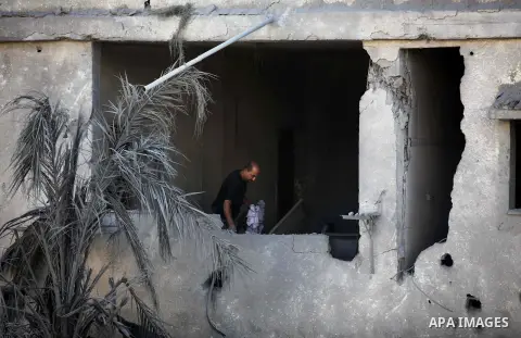 A Palestinian man inspects his house that witnesses said was damaged during an Israeli airstrike in Gaza City August 20, 2014. Hamas militants in the Gaza Strip fired rockets at Israel for a second day on Wednesday after...
