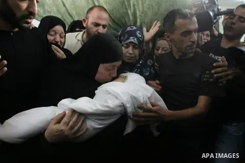 Relatives of the wife of Hamas's military leader, Mohammed Deif, and his infant son Ali, whom medics said were killed in Israeli air strikes, mourn during their funeral in the northern Gaza Strip August 20, 2014. Israeli...