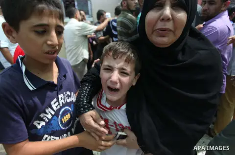 Palestinian relatives of Mohammed Abu Shammala, one of three senior Hamas commanders who were killed in an Israeli air strike, mourns during his funeral in Rafah in the southern Gaza Strip August 21, 2014. Israel killed...