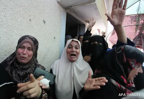 Palestinian relatives of Mohammed Abu Shammala, one of three senior Hamas commanders who were killed in an Israeli air strike, mourns during his funeral in Rafah in the southern Gaza Strip August 21, 2014. Israel killed...