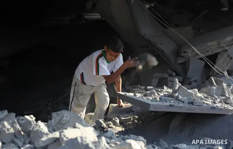 A Palestinian boy inspects the remains of a mosque , which witnesses said was destroyed in an Israeli air strike, in Khan Younis in the southern Gaza strip August 23, 2014. Hamas-led gunmen in Gaza executed 18 Palestinia...