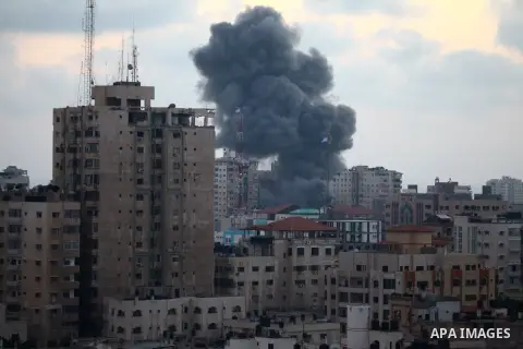 An apartment building (C) collapses just after it was hit by missiles during an Israeli air strike on the heart of Gaza City on August 23, 2014, wounding at least 18 people, four of them children. Residents in the 11-sto...