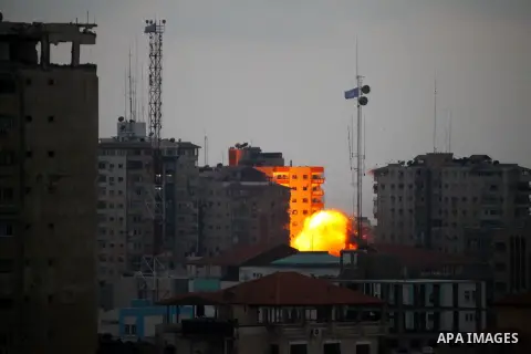 A ball of fire rises from an explosion on al-Zafer apartment tower following an Israeli air strike in Gaza City, in the northern Gaza Strip, Saturday, Aug. 23, 2014. Israeli aircraft fired two missiles at a 12-story apar...