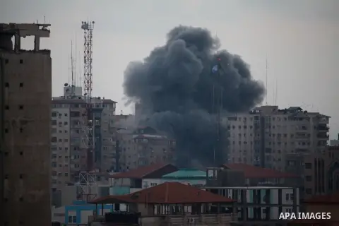 An apartment building (C) collapses just after it was hit by missiles during an Israeli air strike on the heart of Gaza City on August 23, 2014, wounding at least 18 people, four of them children. Residents in the 11-sto...