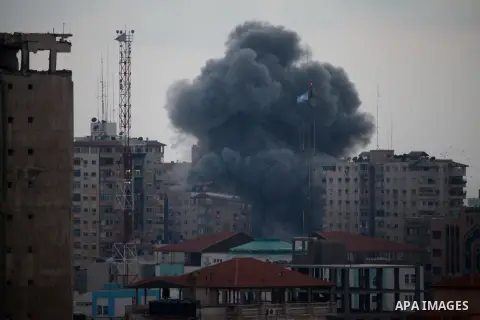 An apartment building (C) collapses just after it was hit by missiles during an Israeli air strike on the heart of Gaza City on August 23, 2014, wounding at least 18 people, four of them children. Residents in the 11-sto...