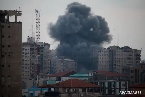 An apartment building (C) collapses just after it was hit by missiles during an Israeli air strike on the heart of Gaza City on August 23, 2014, wounding at least 18 people, four of them children. Residents in the 11-sto...
