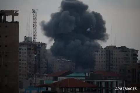 An apartment building (C) collapses just after it was hit by missiles during an Israeli air strike on the heart of Gaza City on August 23, 2014, wounding at least 18 people, four of them children. Residents in the 11-sto...